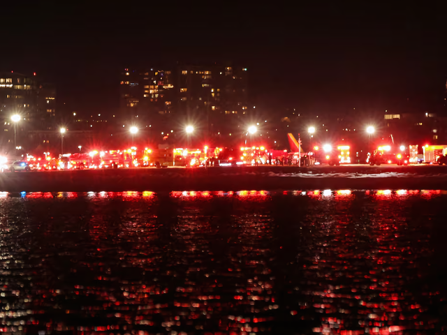 Emergency vehicles converge on the crash site after American Eagle Flight 5342 collided with a helicopter near Reagan National Airport and plunged into the Potomac River/Reuters