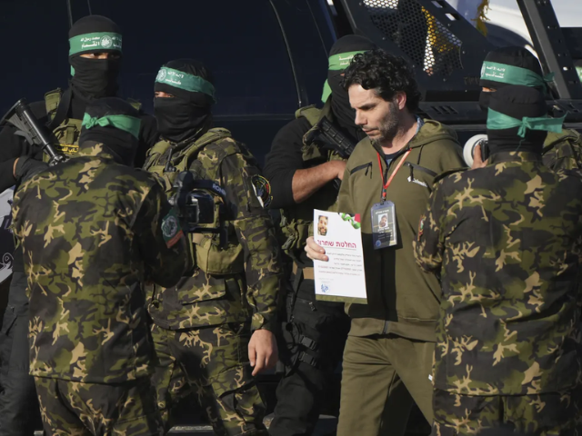 | Israeli Ofer Kalderon who has been held hostage by Hamas in Gaza since October 7, 2023, walks next to Hamas fighters before being handed over to the Red Cross by Hamas fighter in Khan Younis, southern Gaza Strip, Saturday Feb. 1, 2025. Photo/Abdel Kareem)